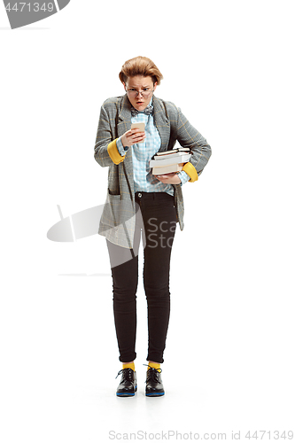 Image of Full length portrait of a surprised female student holding books isolated on white background