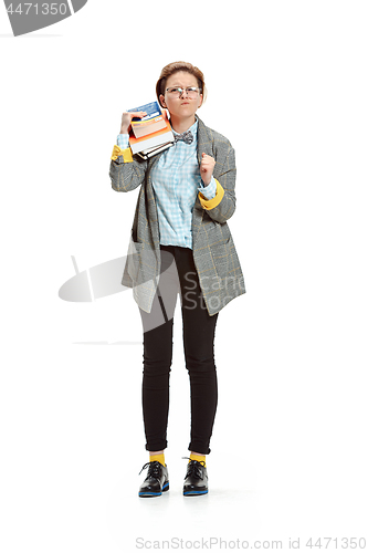 Image of Full length portrait of a angry female student holding books isolated on white background