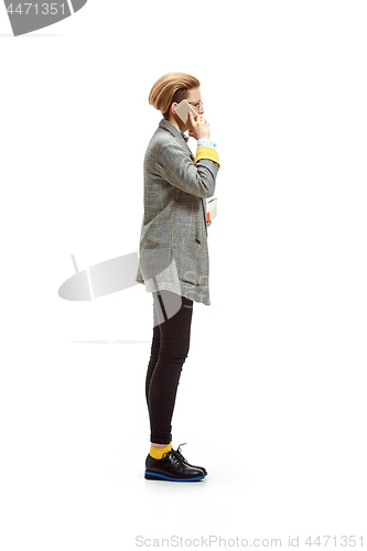 Image of Full length portrait of a happy smiling female student holding books isolated on white background