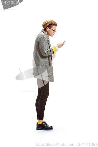 Image of Full length portrait of a happy smiling female student holding books isolated on white background
