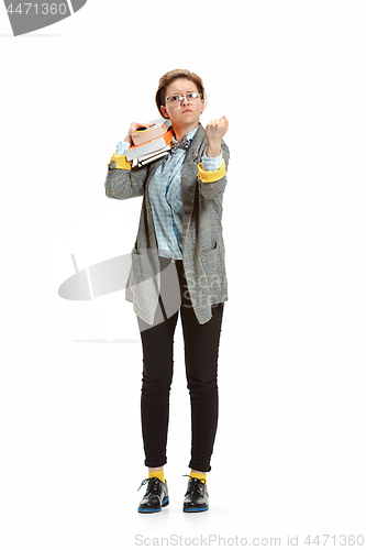 Image of Full length portrait of a angry female student holding books isolated on white background