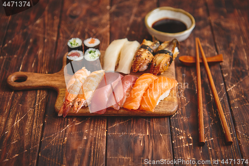 Image of Sushi Set. Different kinds of sushi rolls on wooden serving board