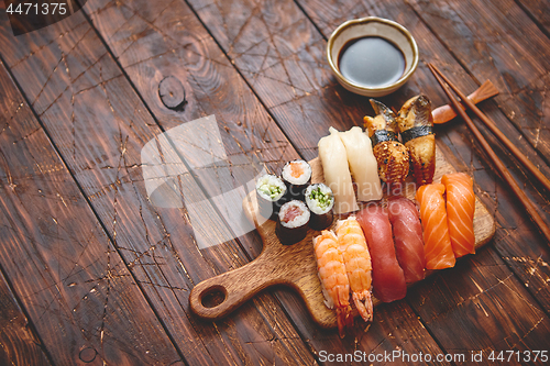 Image of Sushi Set. Different kinds of sushi rolls on wooden serving board