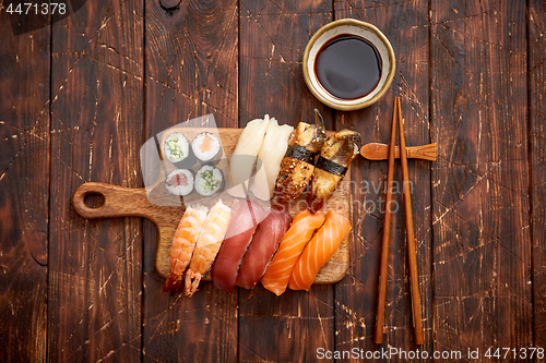 Image of Sushi Set. Different kinds of sushi rolls on wooden serving board