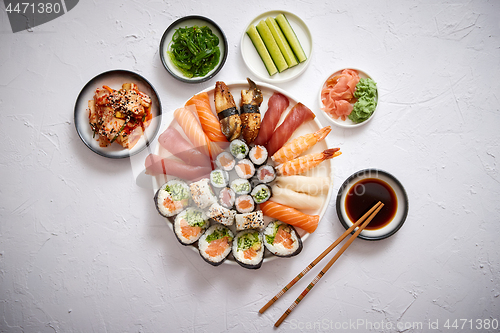 Image of Various sushi rolls placed on round ceramic plate