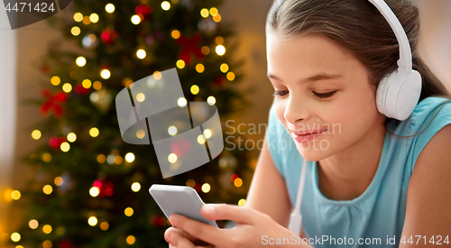 Image of close up of girl with smartphone and headphones