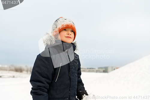 Image of happy little boy in winter clothes outdoors