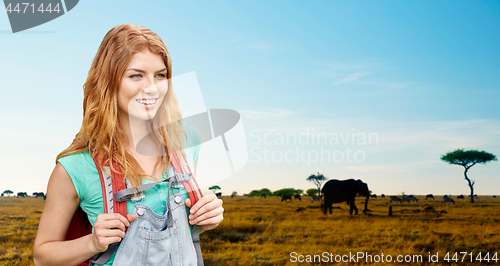 Image of happy woman with backpack over african savannah