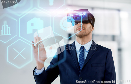 Image of businessman with virtual reality headset at office