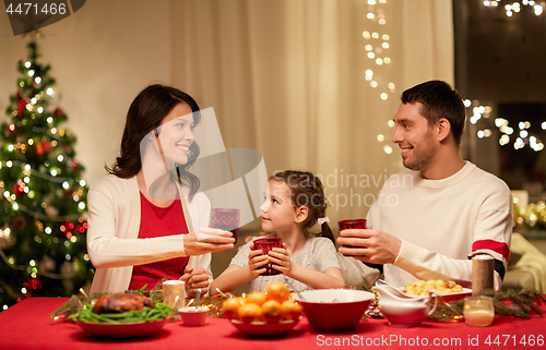 Image of happy family having christmas dinner at home