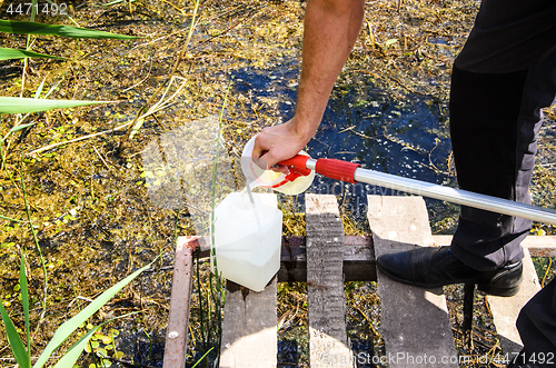 Image of Take samples of water for laboratory testing. The concept - analysis of water purity, environment, ecology.