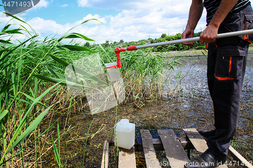 Image of Take samples of water for laboratory testing. The concept - analysis of water purity, environment, ecology.