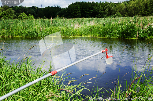 Image of Take samples of water for laboratory testing. The concept - analysis of water purity, environment, ecology.