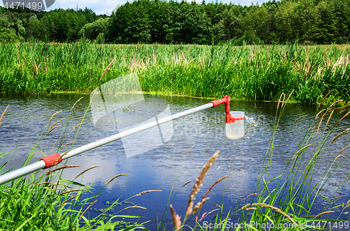 Image of Take samples of water for laboratory testing. The concept - analysis of water purity, environment, ecology.