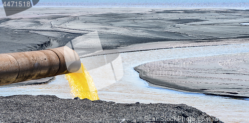 Image of The industrial wastewater is discharged from the pipe into the water