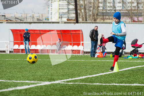 Image of Boy kicking soccer ball