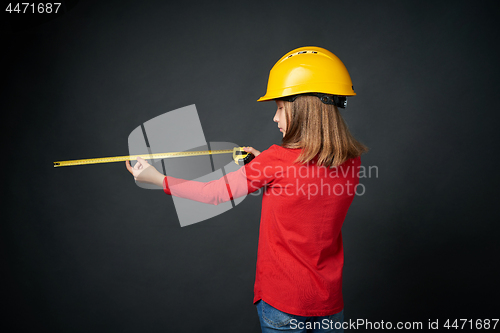 Image of Decoration, renovation and reconstrucion concept. Girl with measuring tape