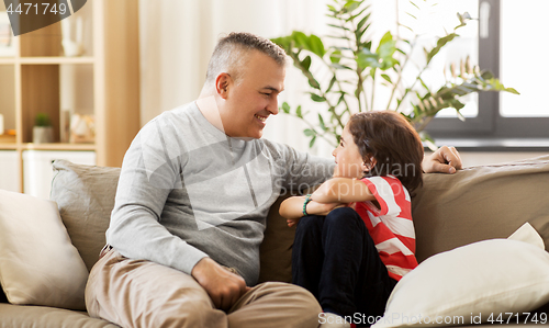 Image of happy father with little son at home