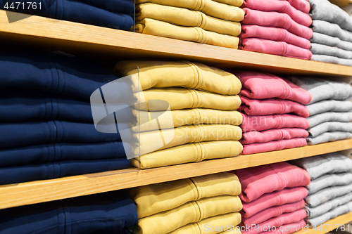 Image of close up of shelves with clothes at clothing store