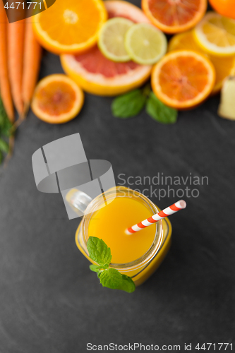 Image of mason jar glass of fruit juice on slate table top