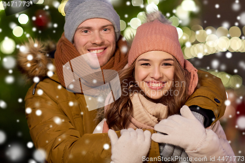 Image of happy couple hugging at christmas tree