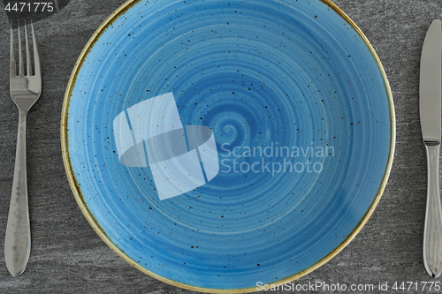 Image of close up of plate, fork and knife on table