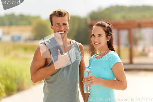 Image of couple with bottle of water after doing sports