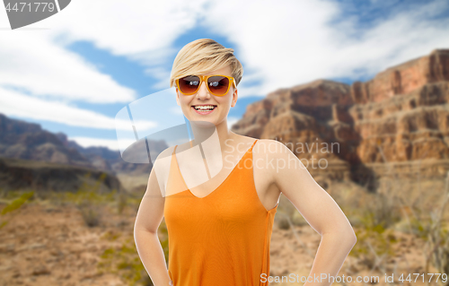 Image of happy smiling teenage girl over grand canyon