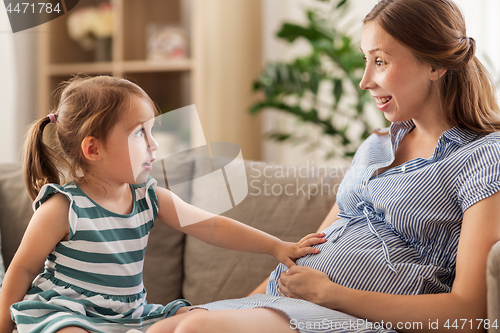 Image of pregnant mother and daughter at home