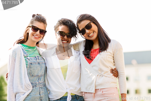 Image of happy young women in sunglasses outdoors