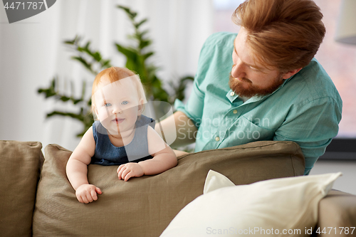 Image of happy father with little baby daughter at home