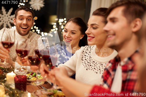 Image of friends celebrating christmas and drinking wine