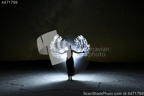 Image of Light Painted Long Exposure Image of a Woman with the Milky Way