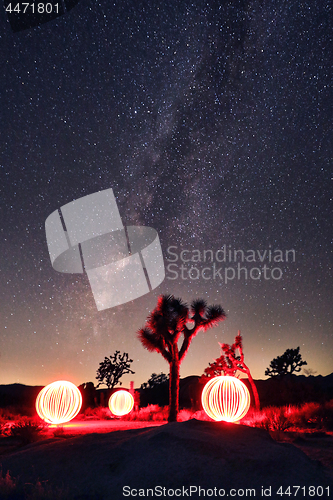 Image of Bright Milky Way Core With Light Painted Orbs in the Landscape