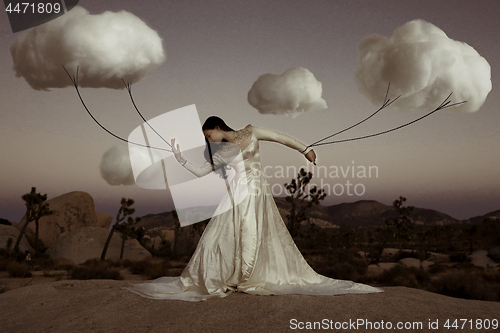 Image of Abstract Concept of Girl Attached to Clouds Representing Fantasy