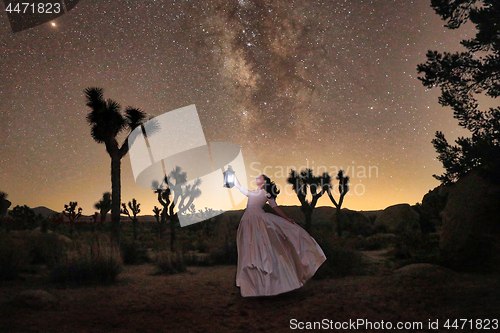 Image of Girl Holding Lantern in the Desert Under the Milky Way