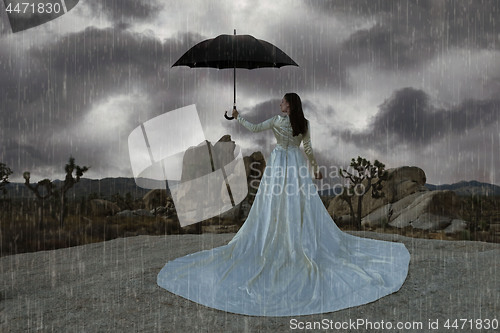 Image of Abstract Concept of Girl Surrounded In Desert Raining