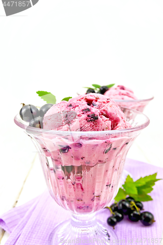 Image of Ice cream with black currant in two glasses on board