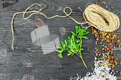 Image of Rue leaves with twine on black board