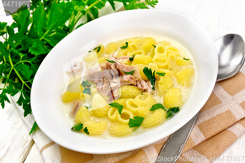 Image of Soup creamy of chicken and pasta in plate on kitchen towel