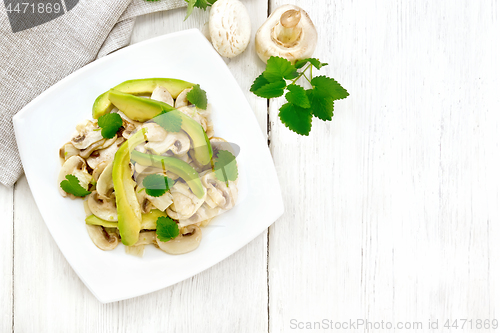 Image of Salad of avocado and champignons on board top