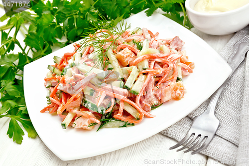 Image of Salad of sausage and spicy carrots with mayonnaise on wooden boa