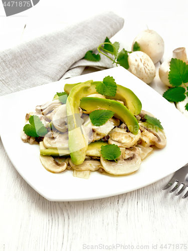 Image of Salad of avocado and champignons on wooden board