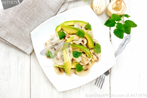 Image of Salad of avocado and champignons on wooden board top