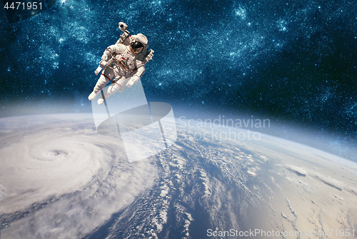 Image of Astronaut in outer space against the backdrop of the planet eart