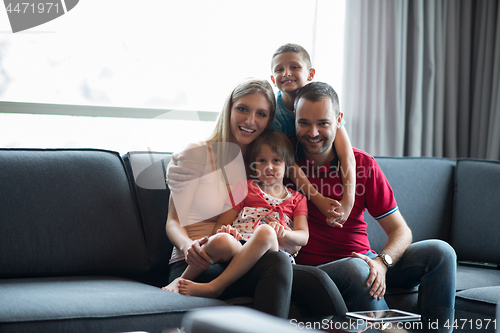 Image of happy young couple spending time with kids