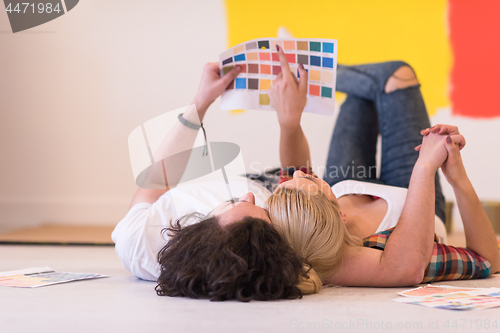 Image of Happy young couple relaxing after painting