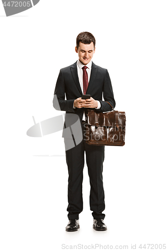 Image of Full body portrait of businessman with briefcase on white