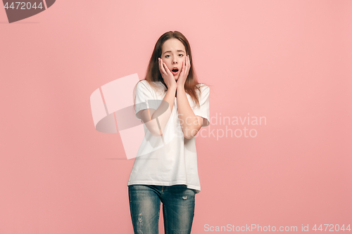 Image of Beautiful teen girl looking suprised isolated on pink