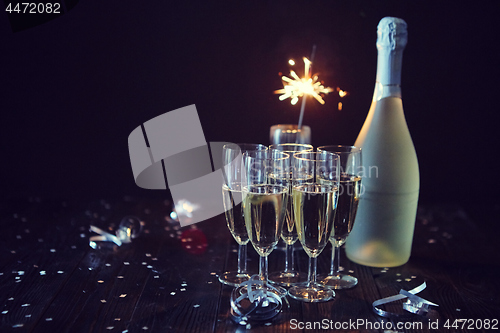 Image of Party composition image. Glasses filled with champagne placed on black table